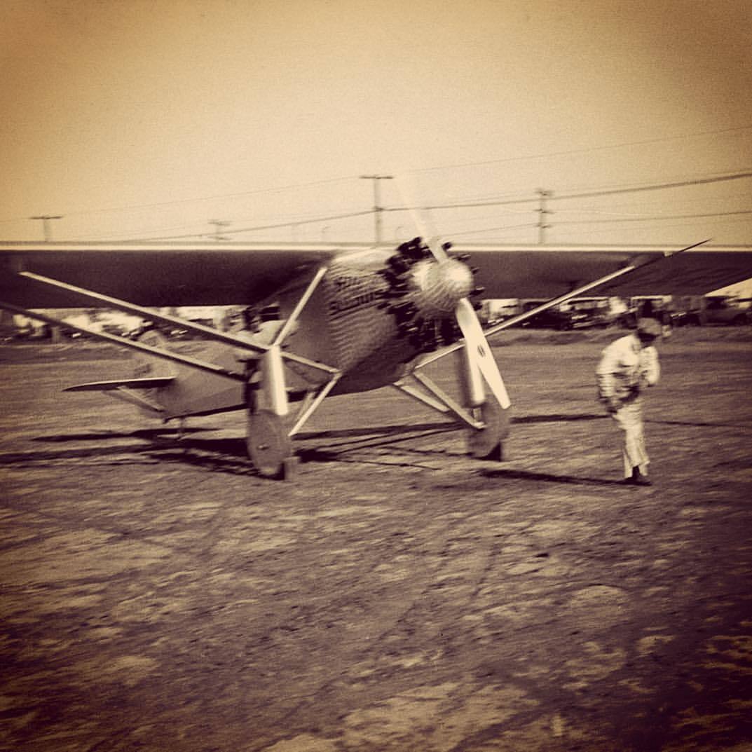 12032844_10105506632231761_8079126009682419672_o - Copy Spirit of St Louis airplane in 1927 with mechanic starting the engine and Charles Lindbergh inside at San Diego, California